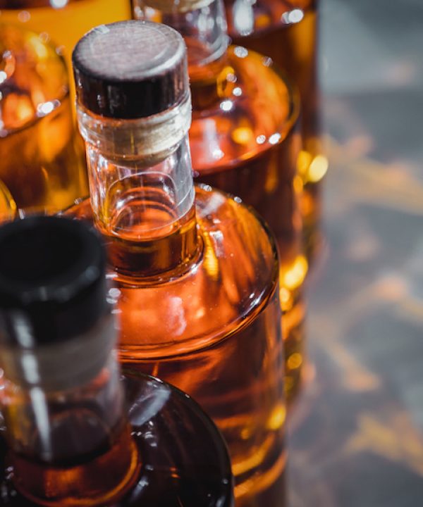 Small liquor production based on maple syrup. Multitude of pure alcohol bottles